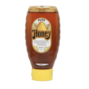 Plastic custom-labeled bottle of honey on its lid.