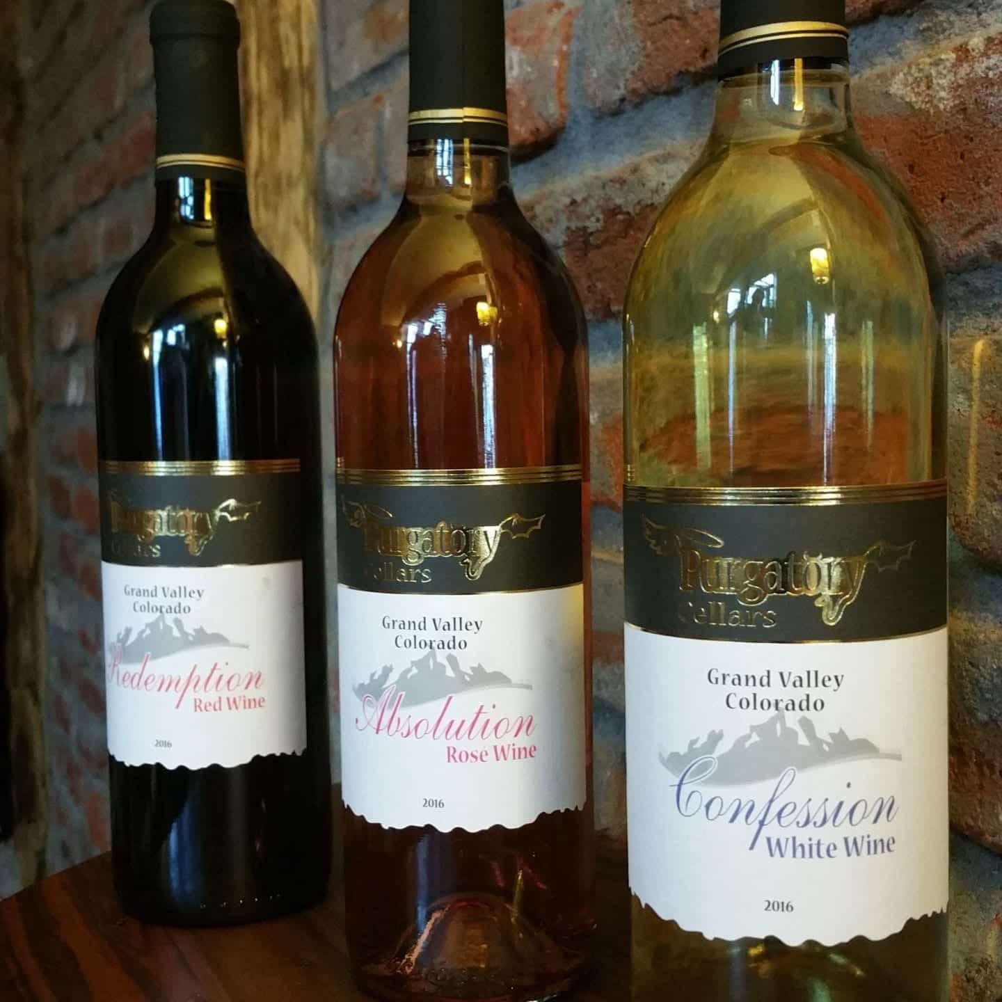 3 bottles of red, rose, and white Purgatory wine with elegant labels made by Columbine Label.
