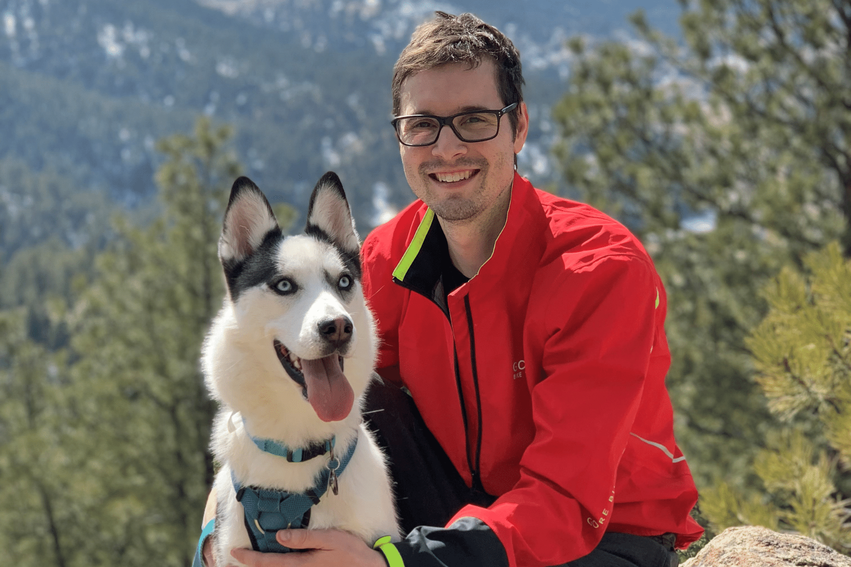 Brett Borzsei Production Manager at Columbine Label Company with his husky on a walk in the mountains.
