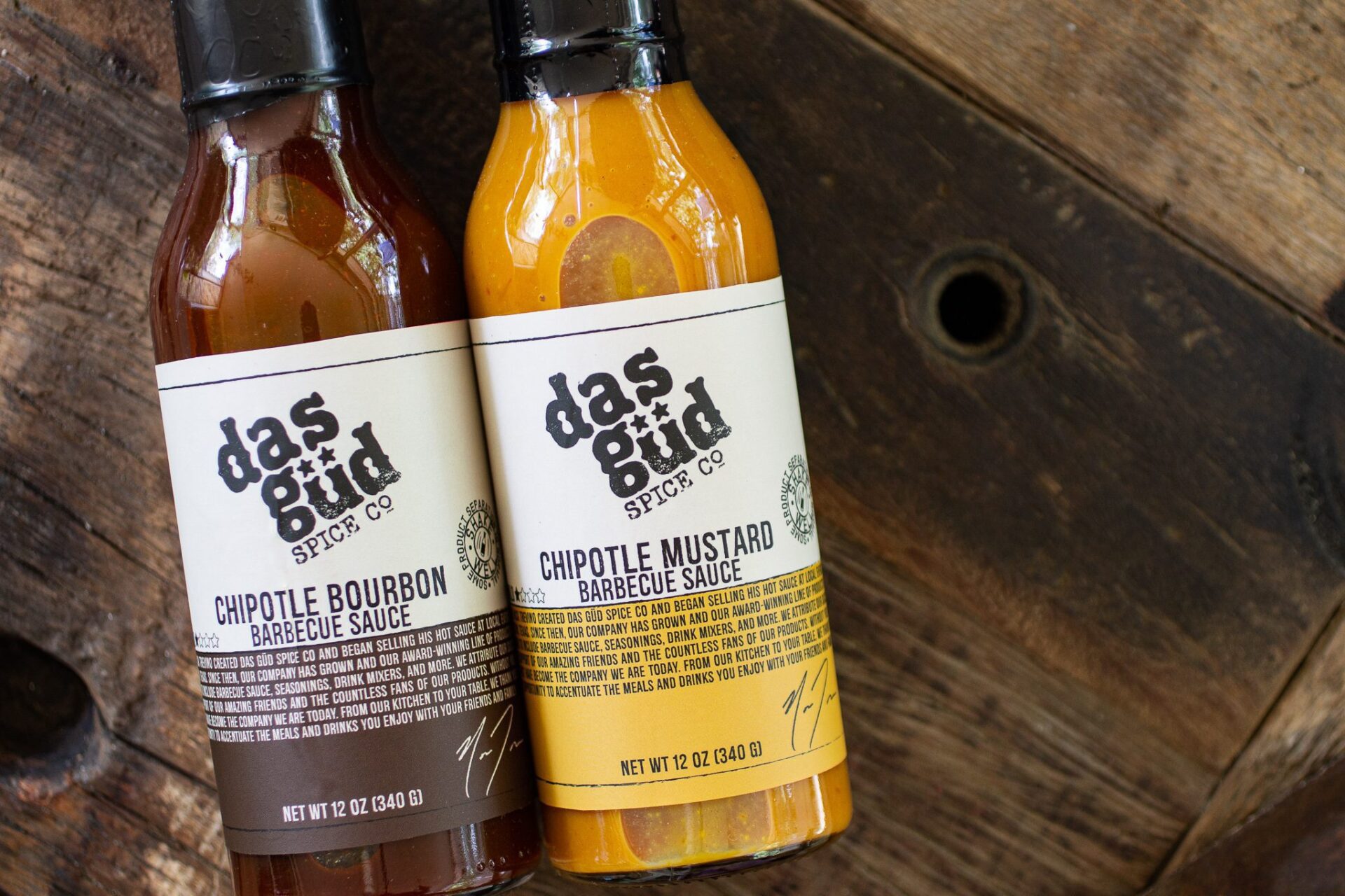 Two bottles of barbecue sauce with custom made labels.